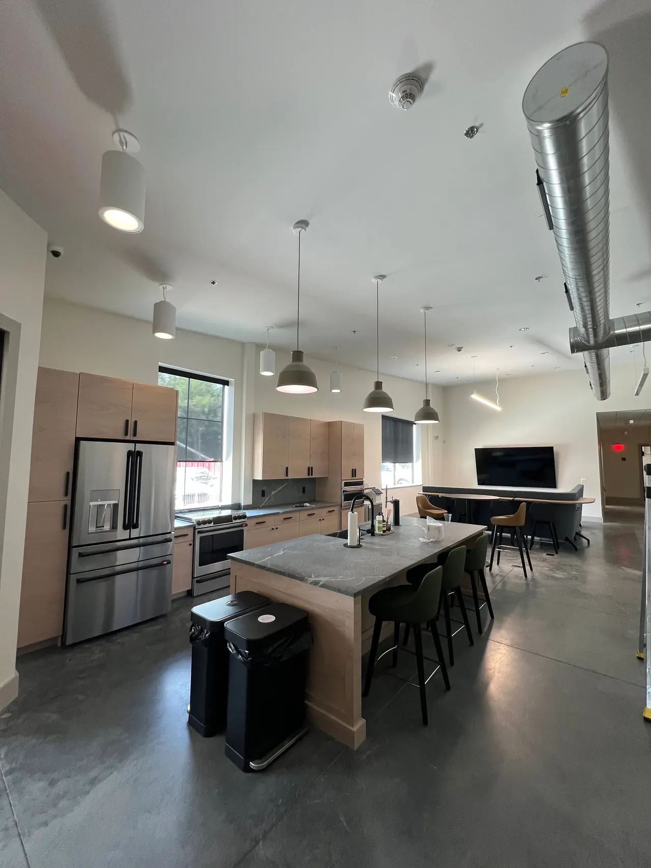 Commercial kitchen with pendant and recessed lighting