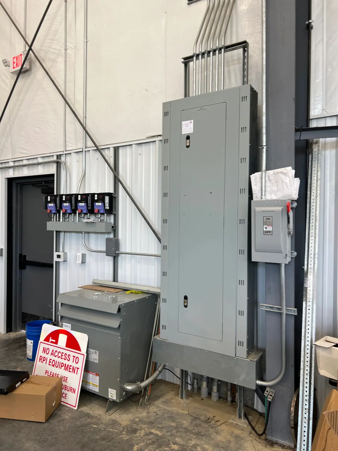 Commercial electrical panel and transformer mounted on a wall