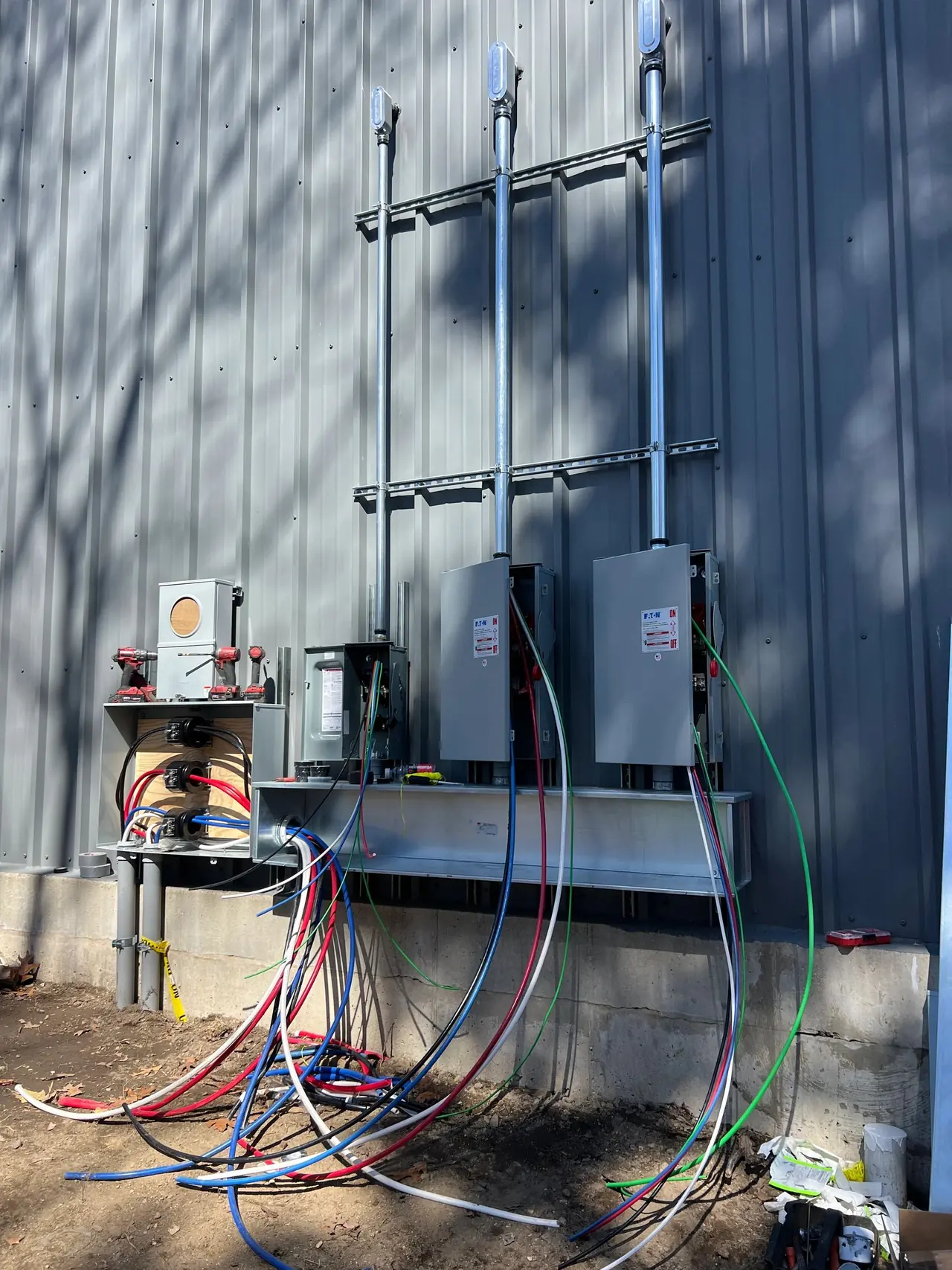 Service equipment with conduit and wiring beside a work van