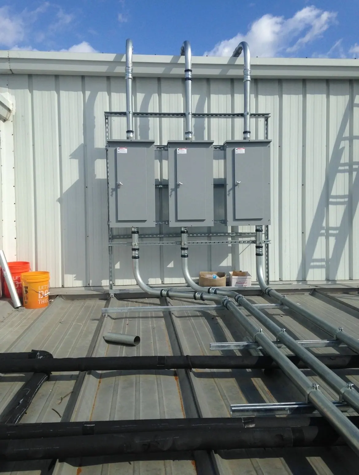 Commercial service equipment and conduit on a metal building