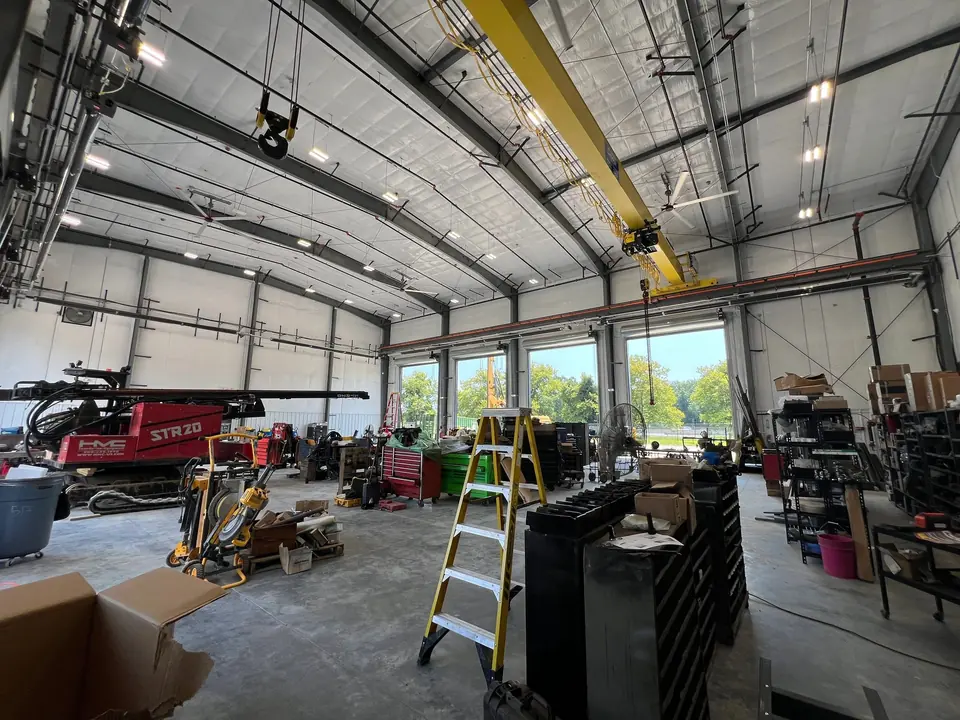 Interior of a large commercial shop with overhead electrical and lighting installed
