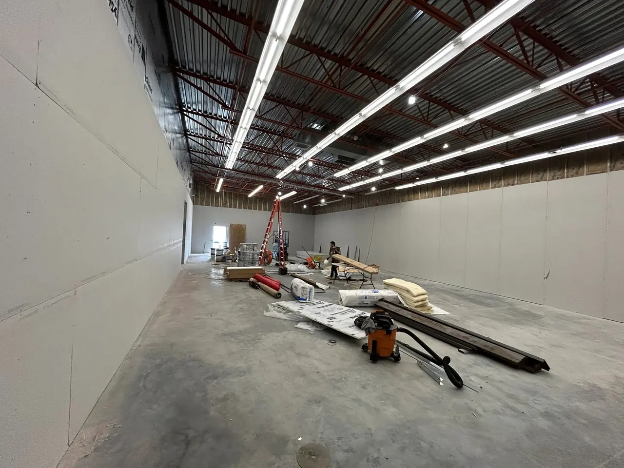 Long warehouse space during build-out with linear lighting