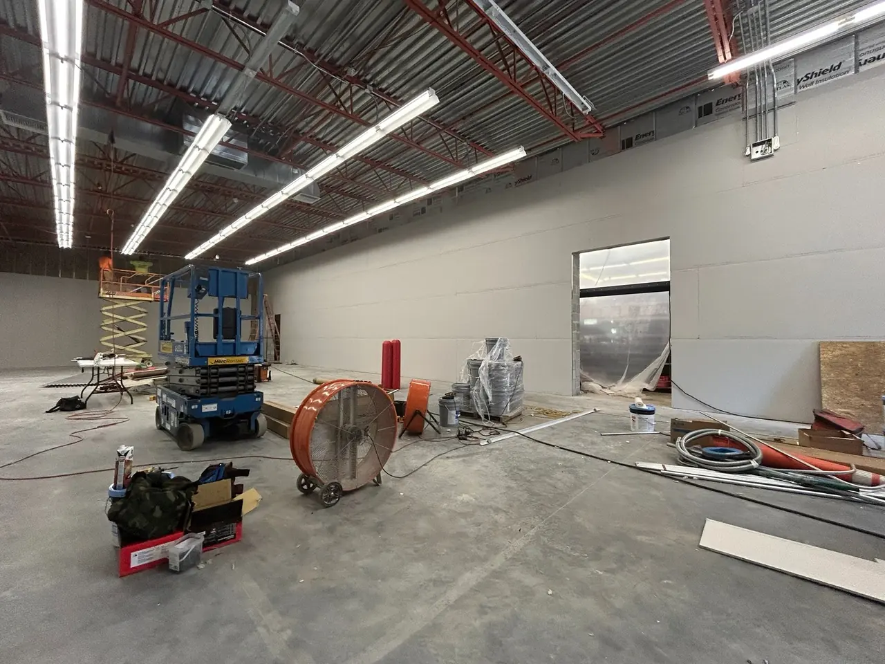 Warehouse interior with new overhead lighting and conduit