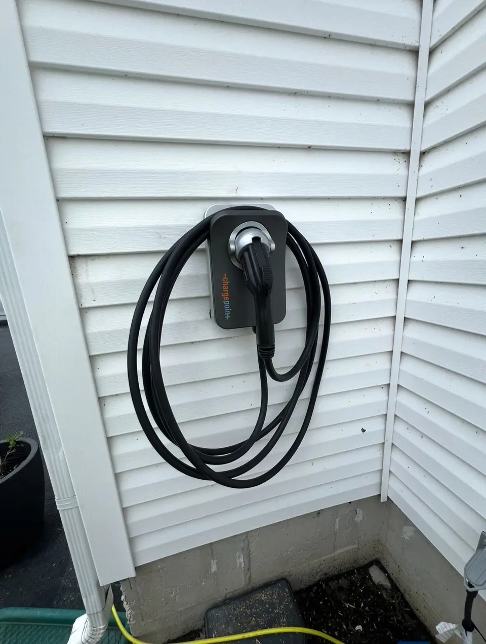 A Level 2 electric vehicle charger mounted on a home’s siding