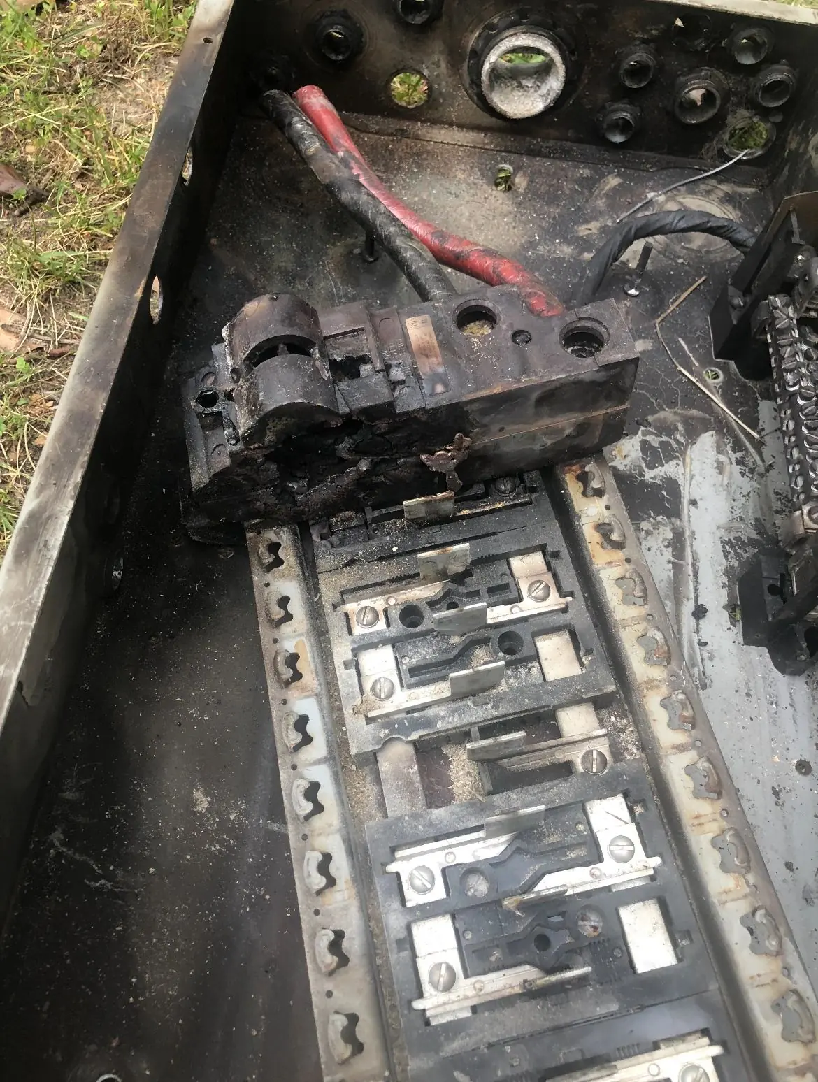 An overheated, burned electrical panel with damaged bussing