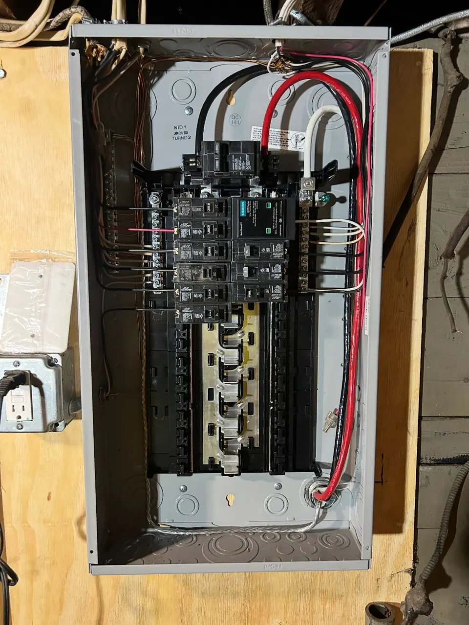 Inside an electrical panel with breakers and wiring