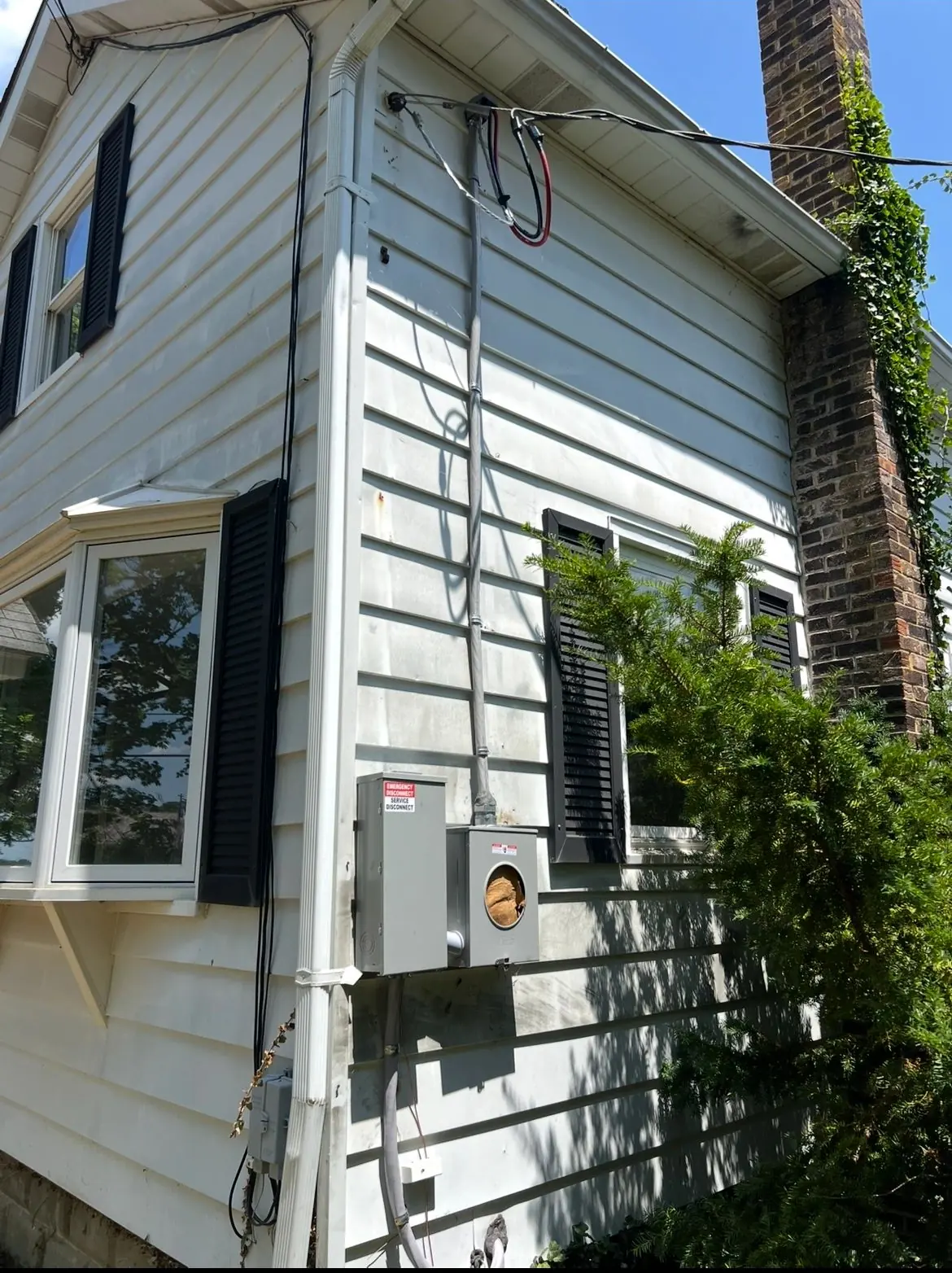 Electrical meter and service entrance on the side of a home